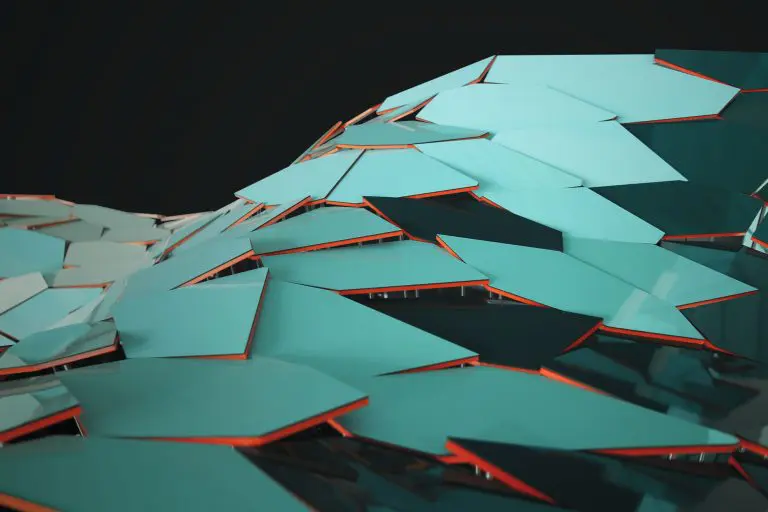 A close-up view of overlapping, glossy turquoise panels with orange edges, arranged in a parametric design that forms an undulating, wave-like pattern against a black background.
