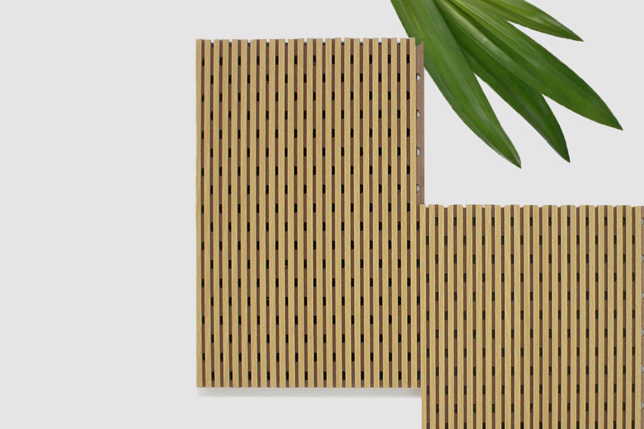 Two rectangular Timberix Microgrooved Panels with evenly spaced vertical slots are arranged on a light background. Green leaves are visible in the top right corner.